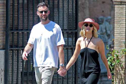 A picture of Jennifer Lawrence and Cooke Maroney walking down street holding one another hand.